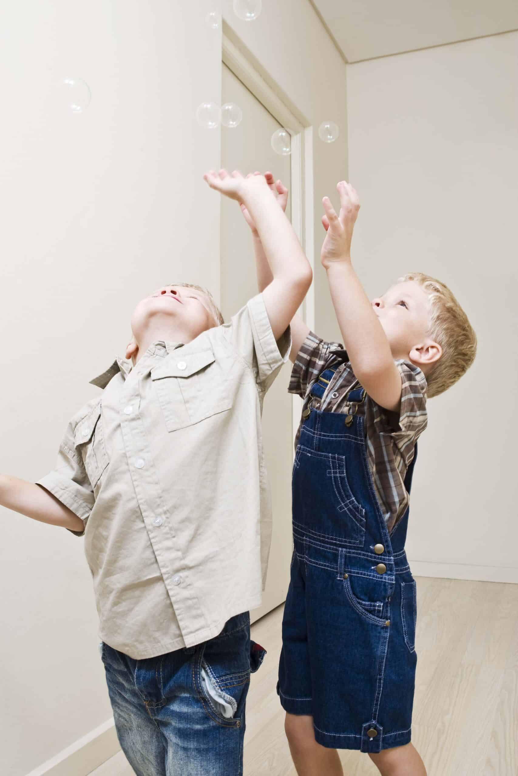 Twin boys playing with bubbles